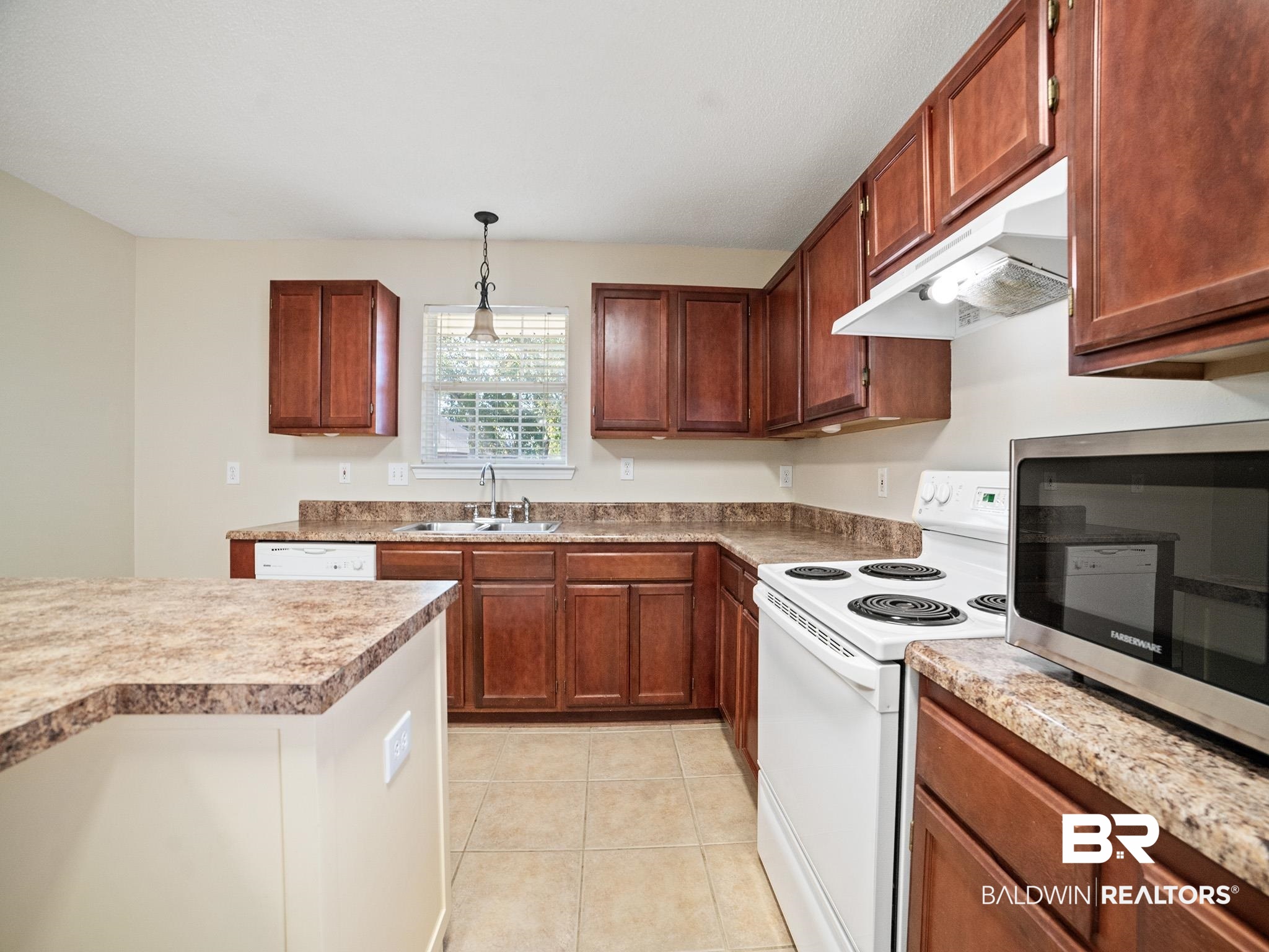 8320 Milton Road Mobile, AL 36695 - Photo 6 of 27 Kitchen featuring hanging light fixtures, sink, white appliances, and light tile patterned flooring