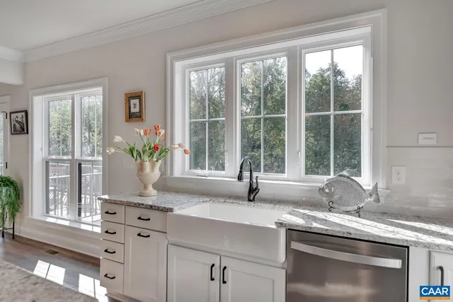 a kitchen with granite countertop a sink and a window