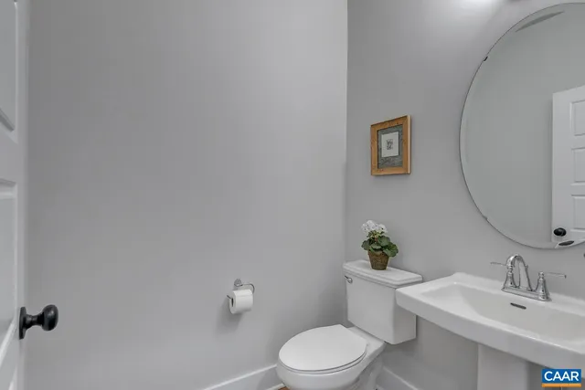 a white toilet sitting next to a bathroom sink