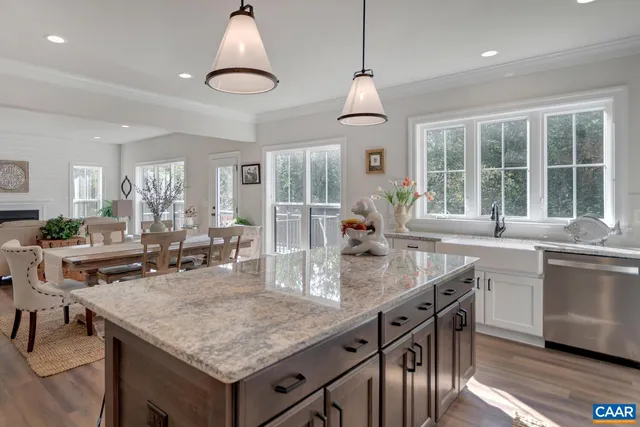 a kitchen with granite countertop center island and stainless steel appliances