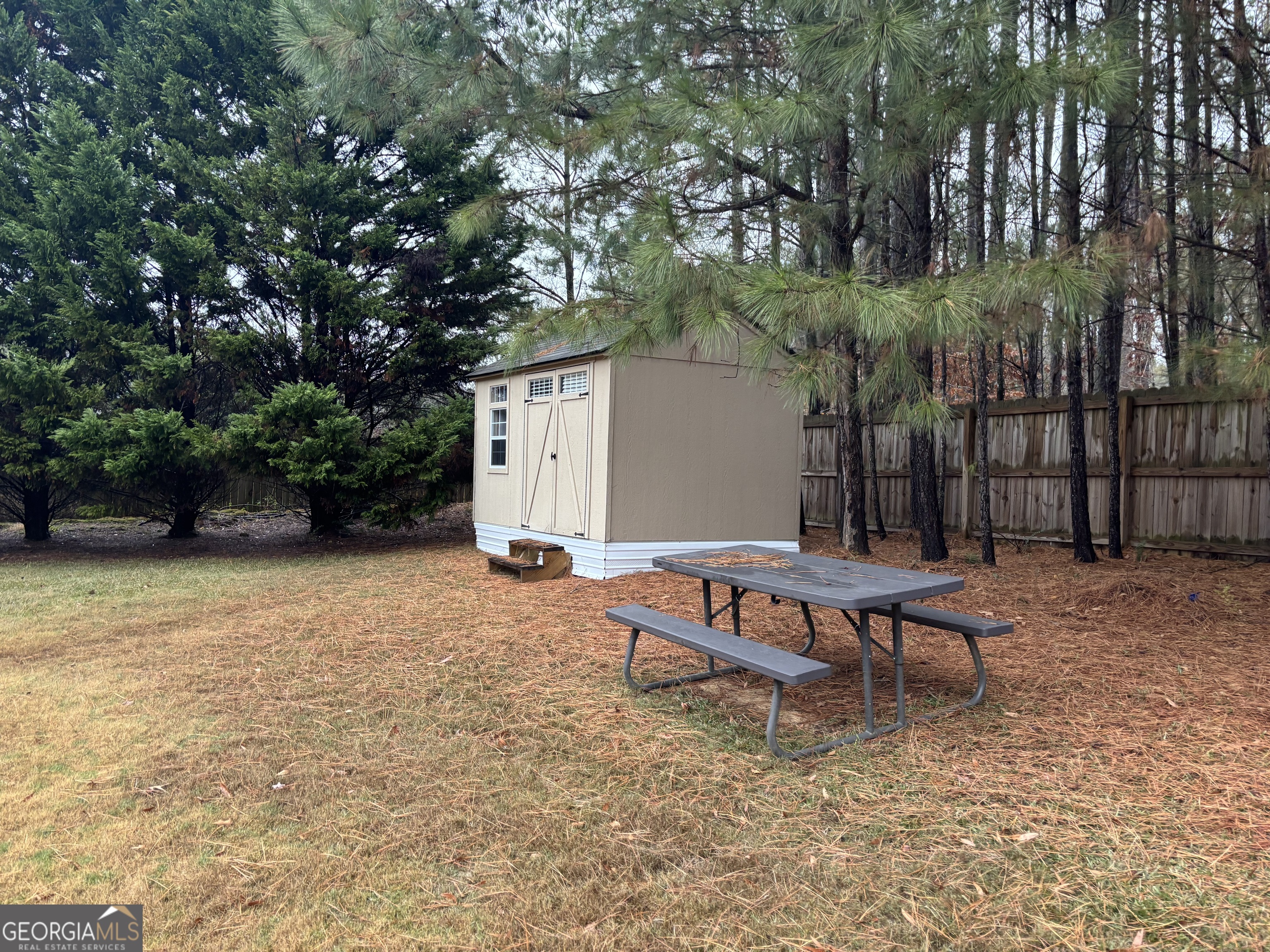 63 Highlander Trail Southwest Rome, GA 30165 - Photo 34 of 49 a backyard of a house with yard and outdoor seating