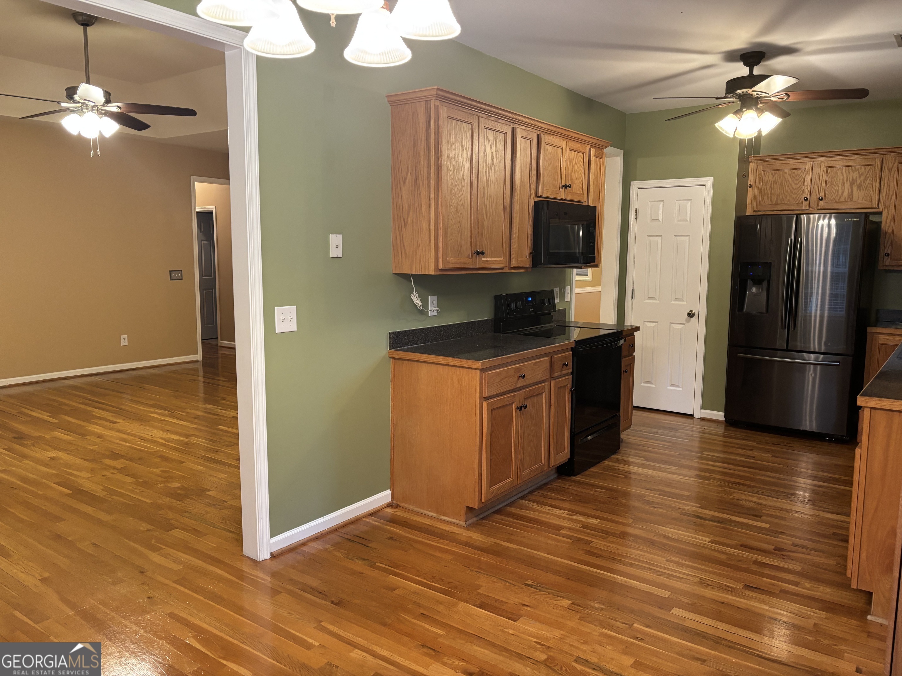 63 Highlander Trail Southwest Rome, GA 30165 - Photo 9 of 49 a kitchen with granite countertop a refrigerator a stove a sink and dishwasher with wooden floor