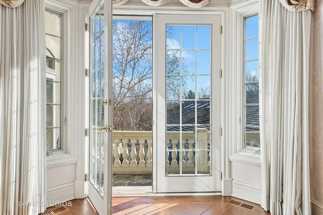 a large living room with a bed furniture and a large window