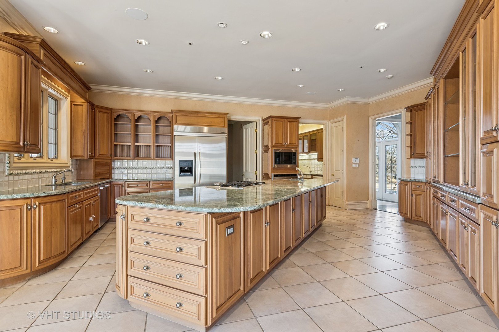 560 Oak Knoll Road Barrington Hills, IL 60010 - Photo 18 of 69 a kitchen with stainless steel appliances kitchen island granite countertop a large counter top and a stove