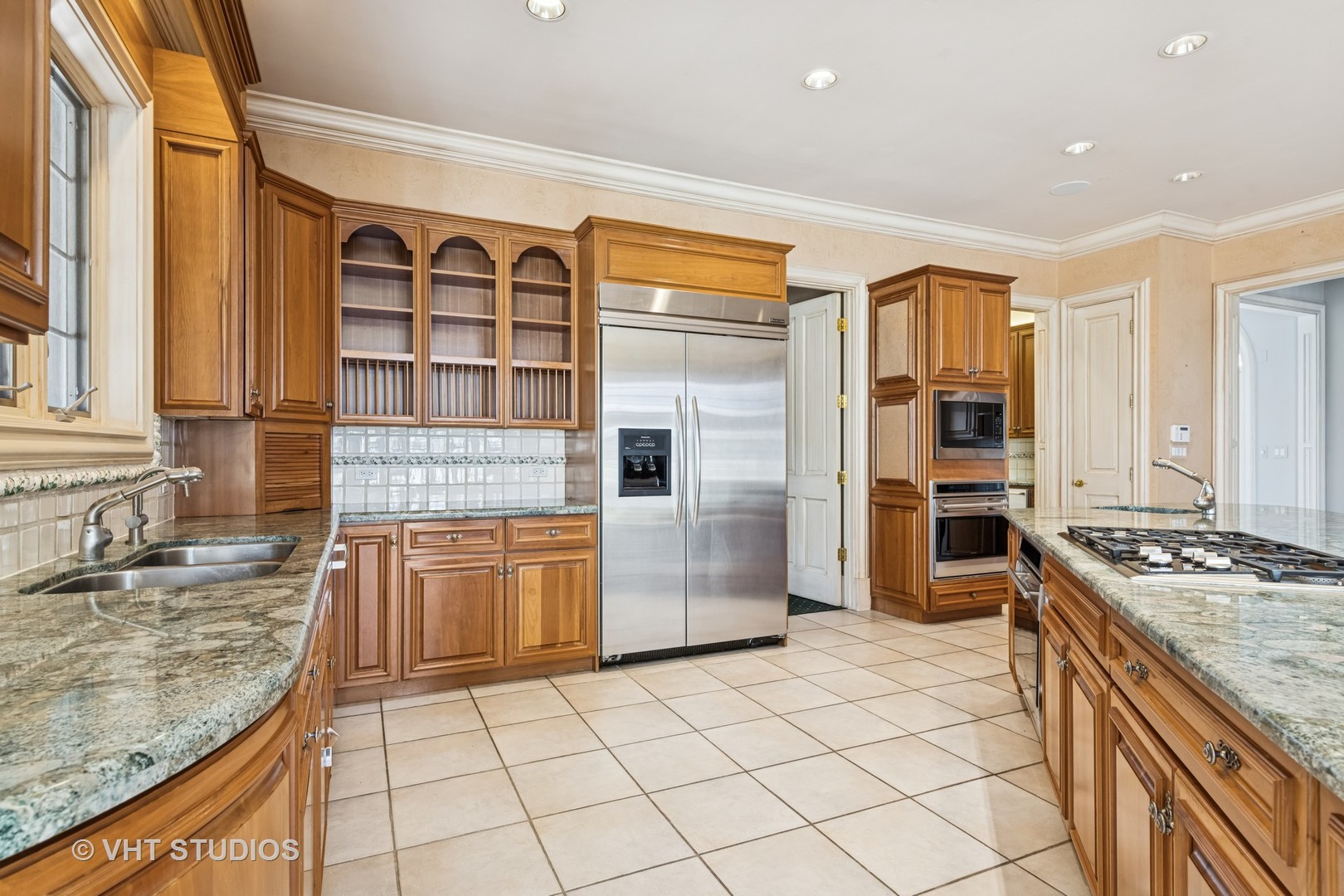 560 Oak Knoll Road Barrington Hills, IL 60010 - Photo 19 of 69 a kitchen with stainless steel appliances granite countertop a stove sink and cabinets