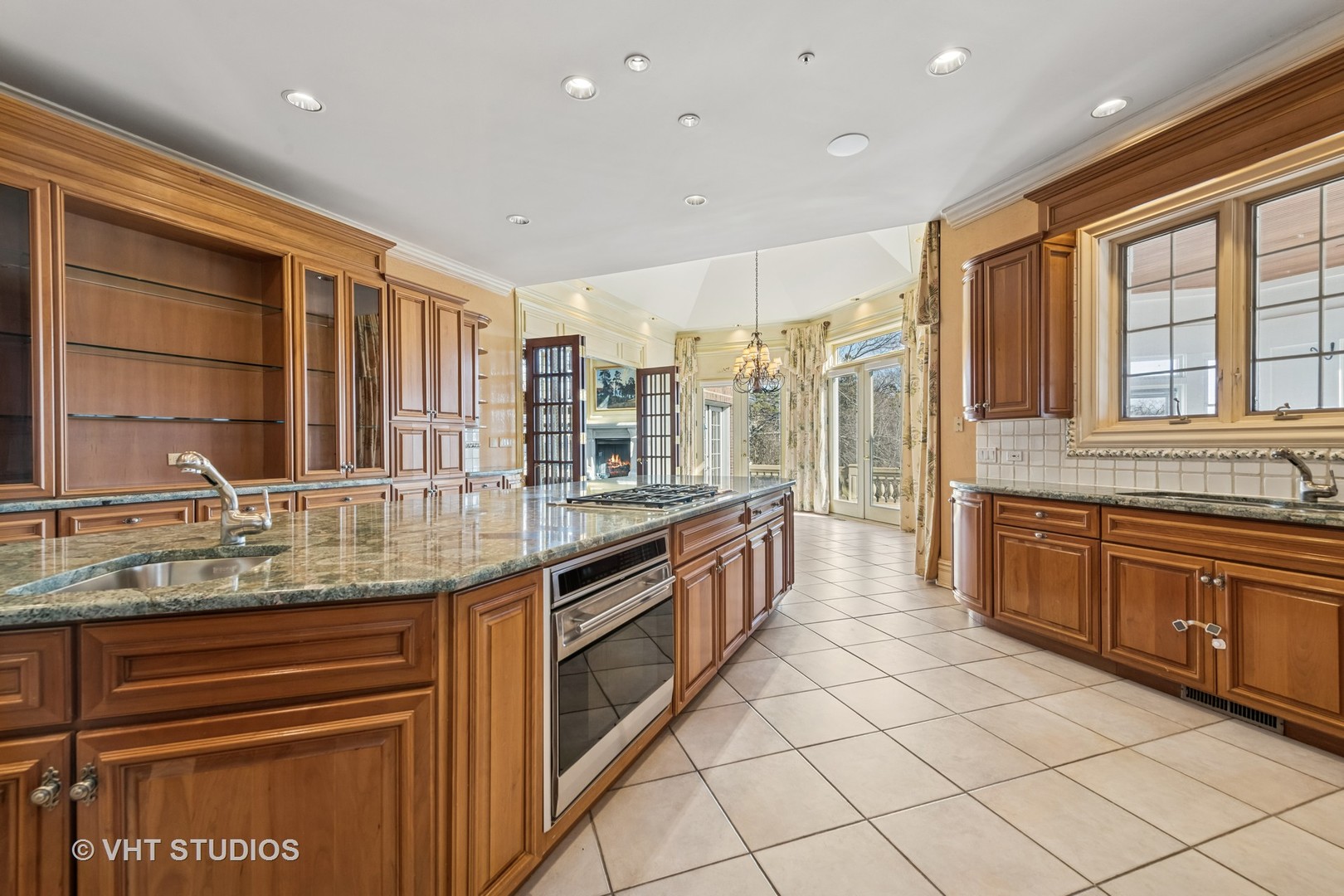 560 Oak Knoll Road Barrington Hills, IL 60010 - Photo 20 of 69 a large kitchen with kitchen island granite countertop a large window and white stainless steel appliances