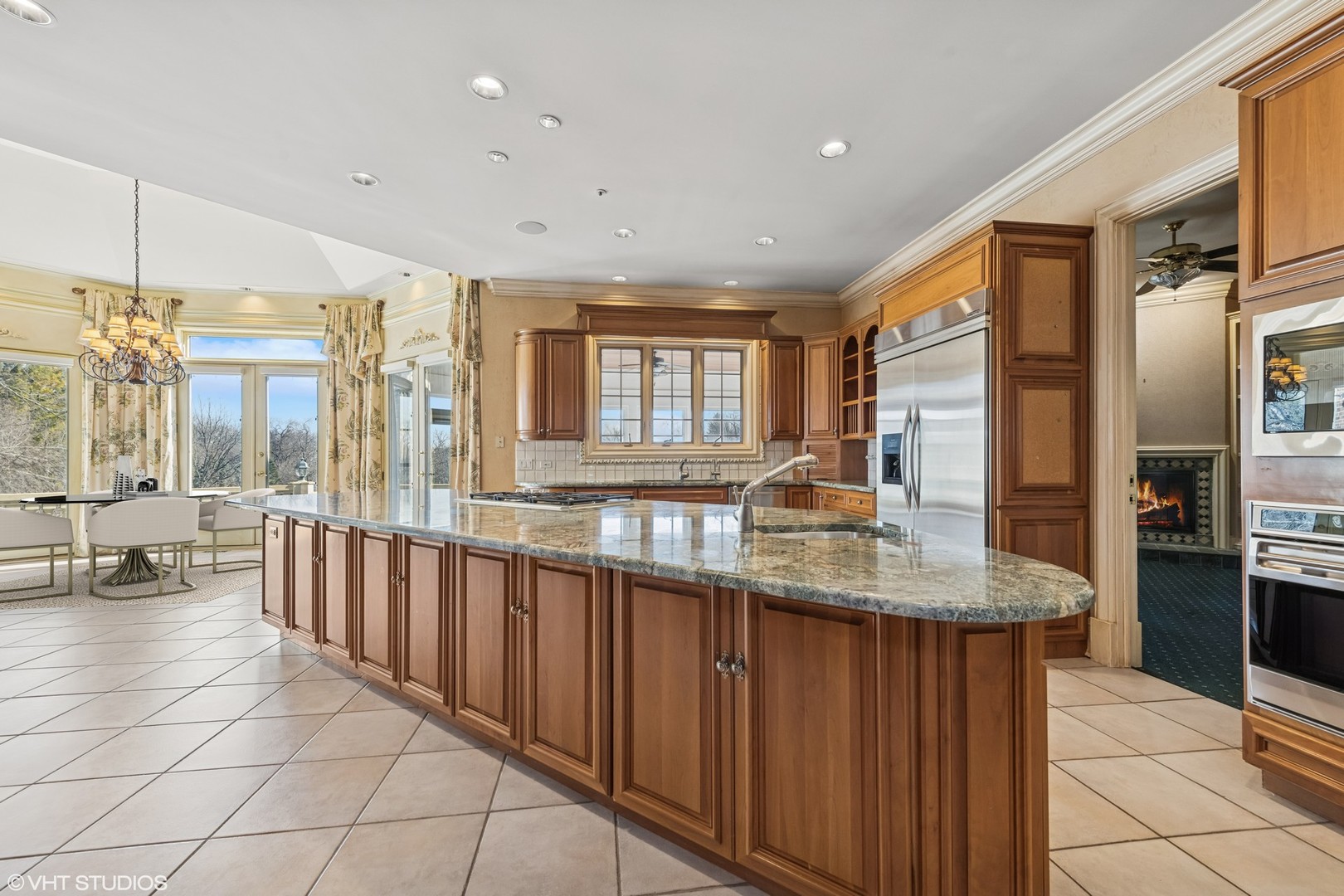 560 Oak Knoll Road Barrington Hills, IL 60010 - Photo 21 of 69 a large kitchen with kitchen island granite countertop a large window and a counter space