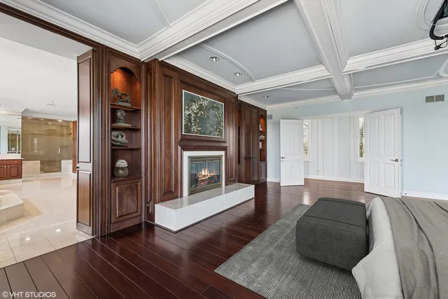 a large white kitchen with a large window and stainless steel appliances
