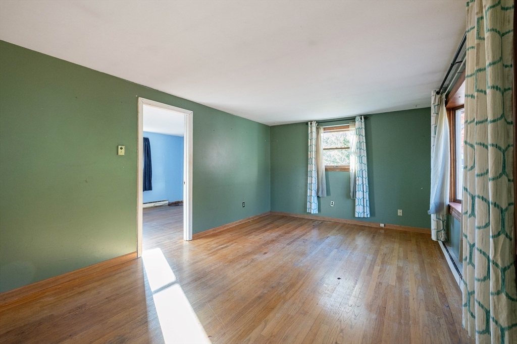 3 Henry Street Chicopee, MA 01020 - Photo 11 of 31 an empty room with wooden floor and windows