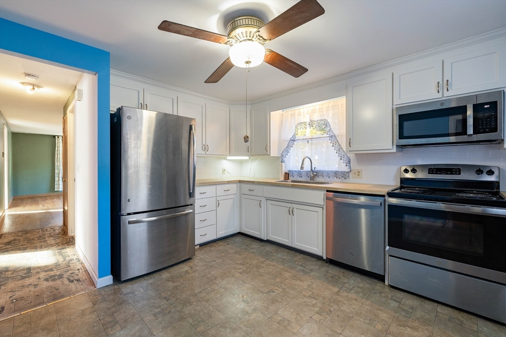 3 Henry Street Chicopee, MA 01020 - Photo 12 of 31 a kitchen with granite countertop a refrigerator stove and microwave