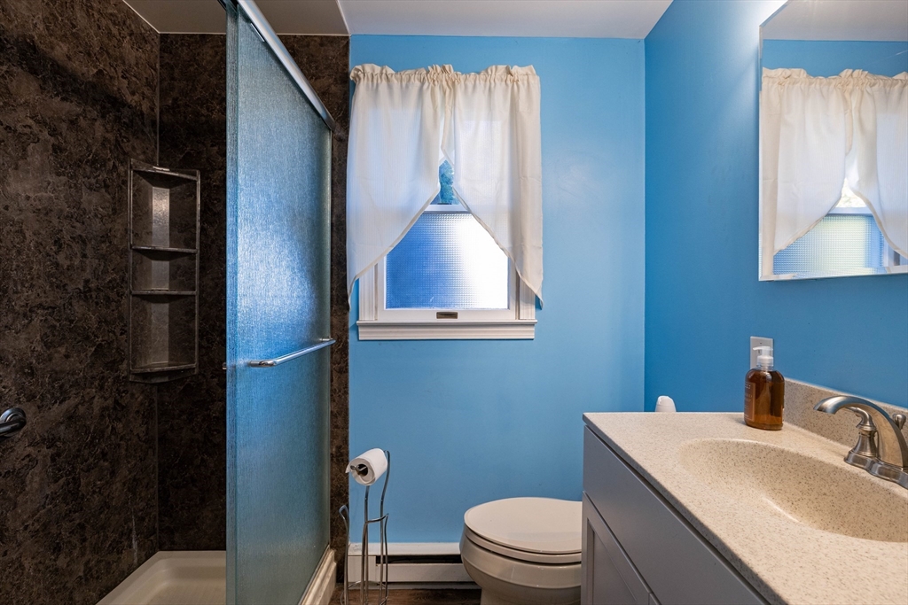 3 Henry Street Chicopee, MA 01020 - Photo 16 of 31 a bathroom with a toilet sink vanity and mirror