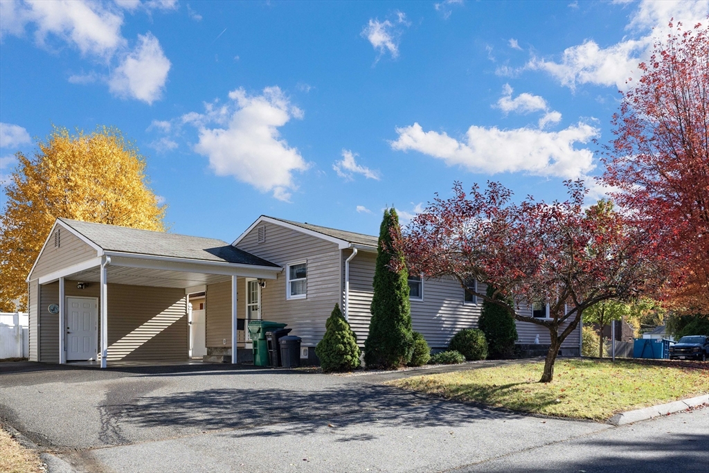 3 Henry Street Chicopee, MA 01020 - Photo 7 of 31 a front view of a house with a yard and garage