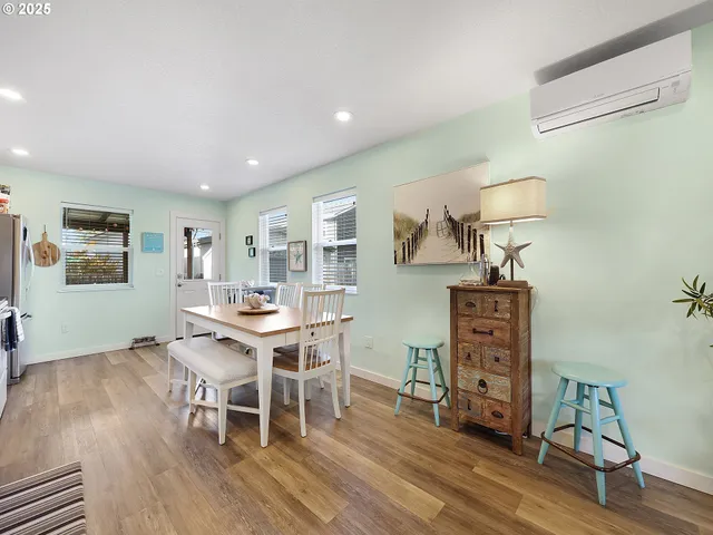 a view of a workspace with furniture and wooden floor