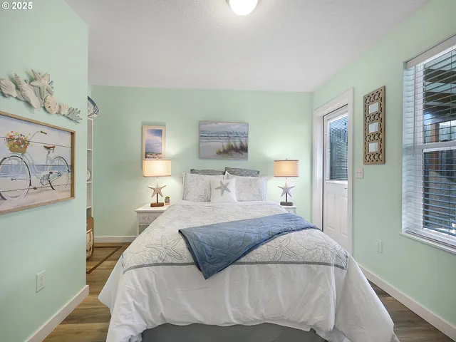 a bedroom with a bed and a painting on the wall