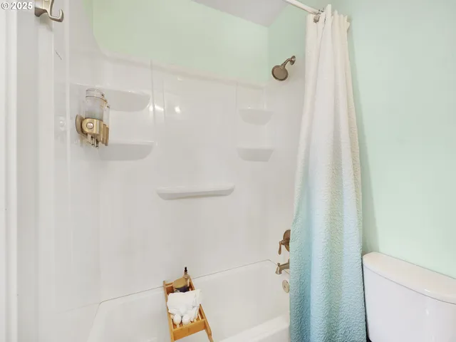 a bathroom with a shower and toilet