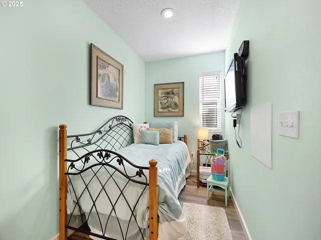 a bedroom with furniture and a flat screen tv