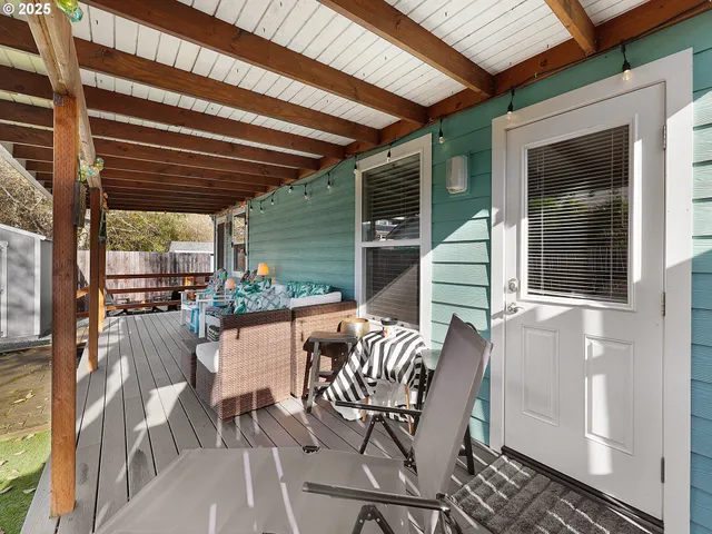 a view of a patio with table and chairs and potted plants