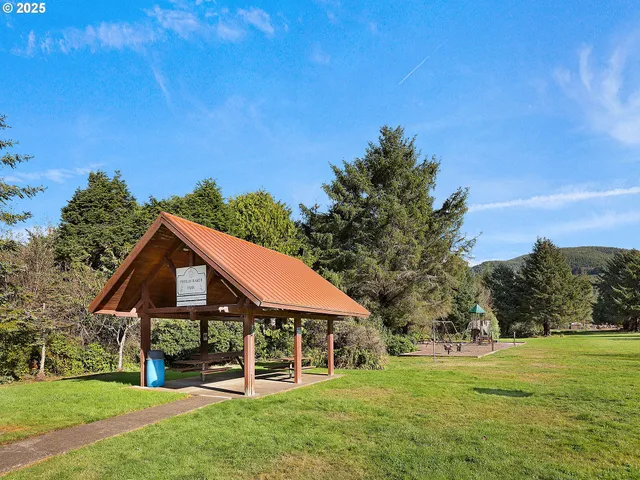a front view of a house with a yard table and trees