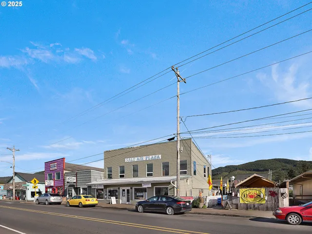 a city street lined with buildings and cars parked in front of it