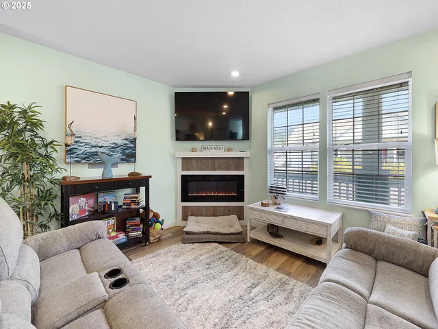 a living room with furniture and a fireplace