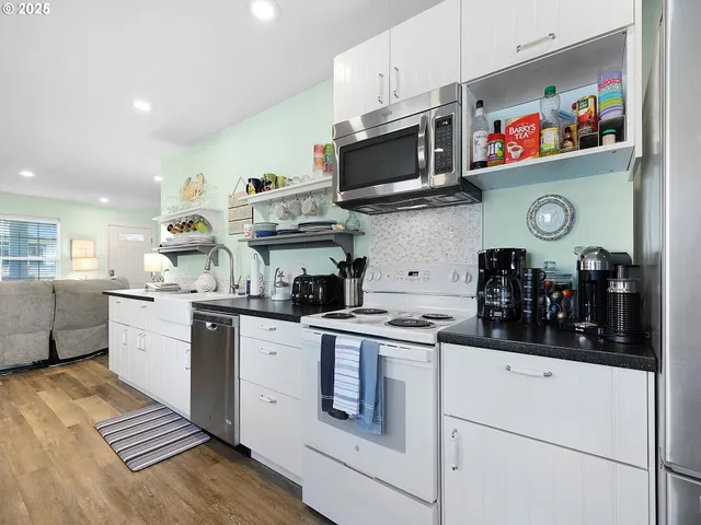 a kitchen with stainless steel appliances granite countertop a sink and cabinets