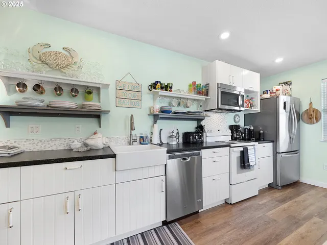 a kitchen with stainless steel appliances granite countertop a sink and wooden cabinets