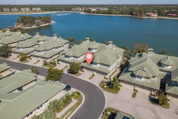 an aerial view of a house with a lake view