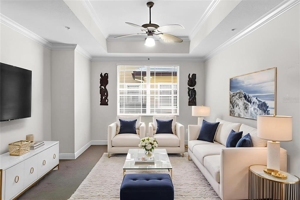 6515 Moorings Point Circle, Unit 102 Lakewood Ranch, FL 34202 - Photo 18 of 61 a living room with furniture and a flat screen tv