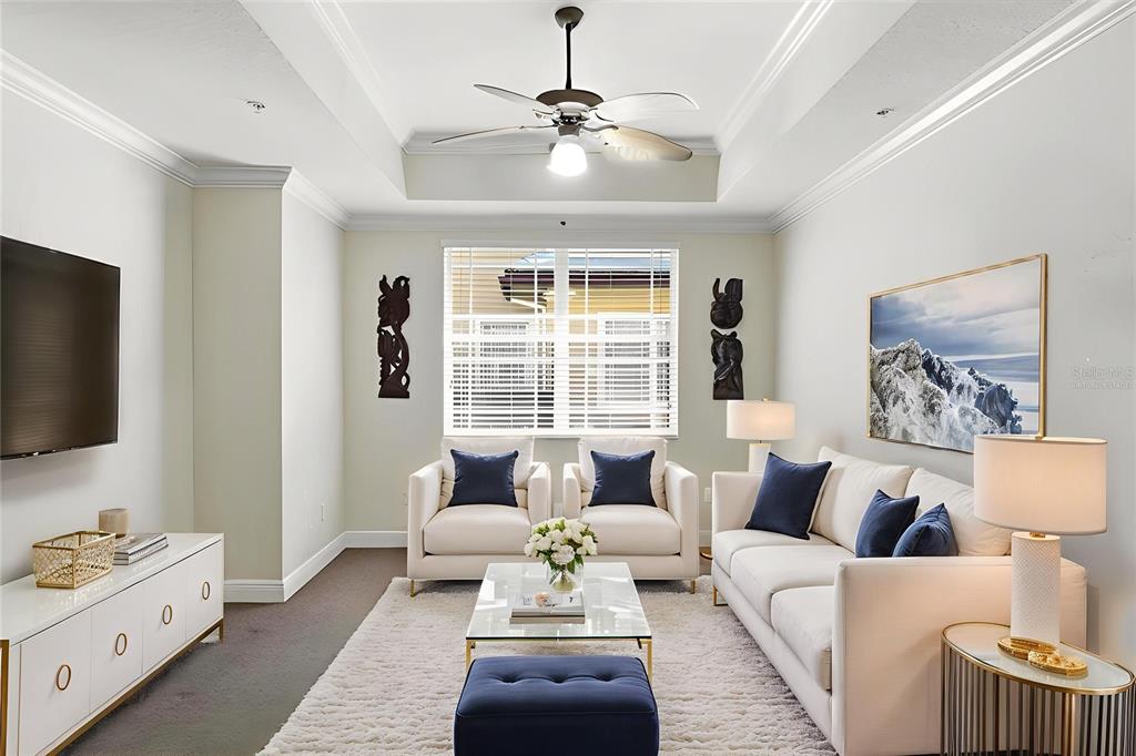 6515 Moorings Point Circle, Unit 102 Lakewood Ranch, FL 34202 - Photo 19 of 52 a living room with furniture and a flat screen tv