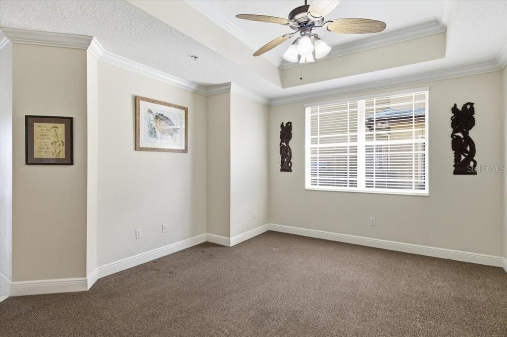 6515 Moorings Point Circle, Unit 102 Lakewood Ranch, FL 34202 - Photo 21 of 52 a view of an empty room with a window and a ceiling fan