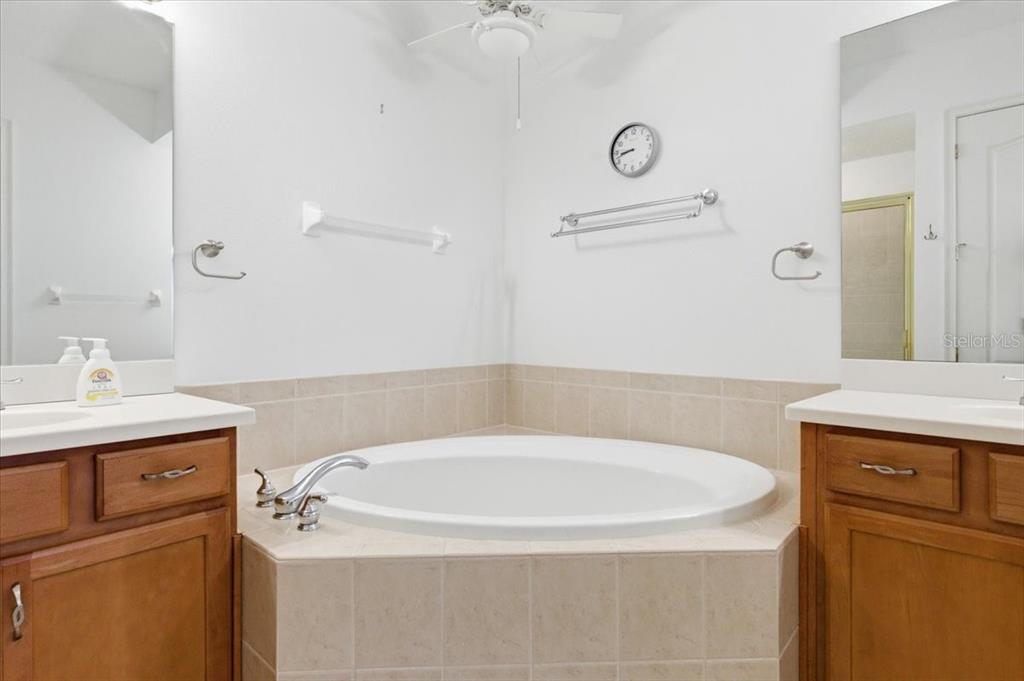 6515 Moorings Point Circle, Unit 102 Lakewood Ranch, FL 34202 - Photo 30 of 61 a bathroom with a bathtub sink and mirror