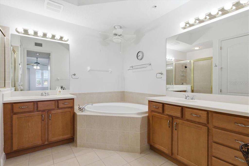 6515 Moorings Point Circle, Unit 102 Lakewood Ranch, FL 34202 - Photo 30 of 52 a bathroom with a sink vanity and mirror