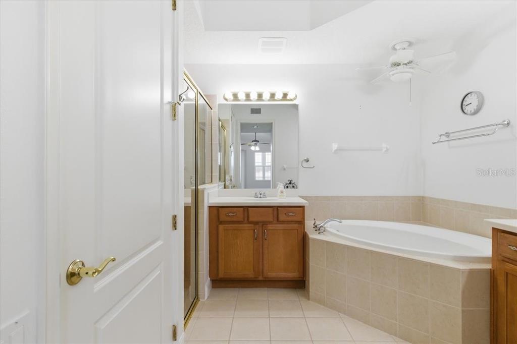 6515 Moorings Point Circle, Unit 102 Lakewood Ranch, FL 34202 - Photo 32 of 61 a bathroom with a tub sink and mirror