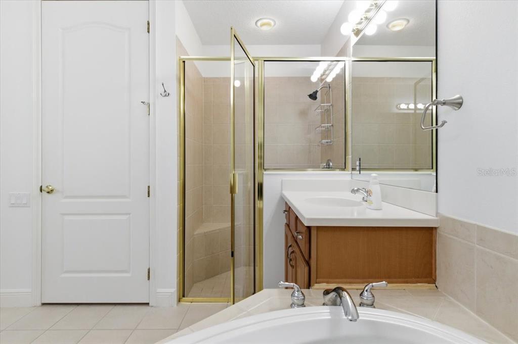 6515 Moorings Point Circle, Unit 102 Lakewood Ranch, FL 34202 - Photo 33 of 61 a bathroom with a sink shower and a mirror
