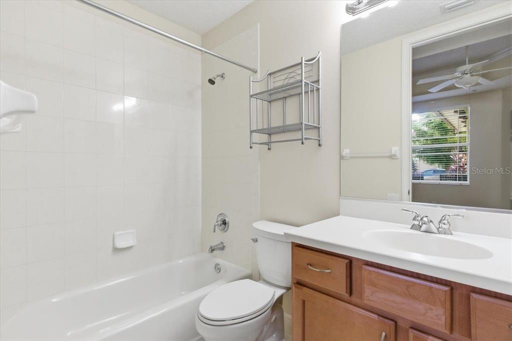 6515 Moorings Point Circle, Unit 102 Lakewood Ranch, FL 34202 - Photo 37 of 61 a bathroom with a sink a toilet and shower