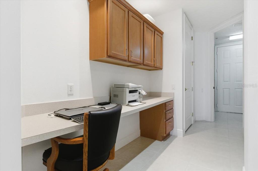 6515 Moorings Point Circle, Unit 102 Lakewood Ranch, FL 34202 - Photo 39 of 52 a kitchen with stainless steel appliances granite countertop a sink stove and refrigerator