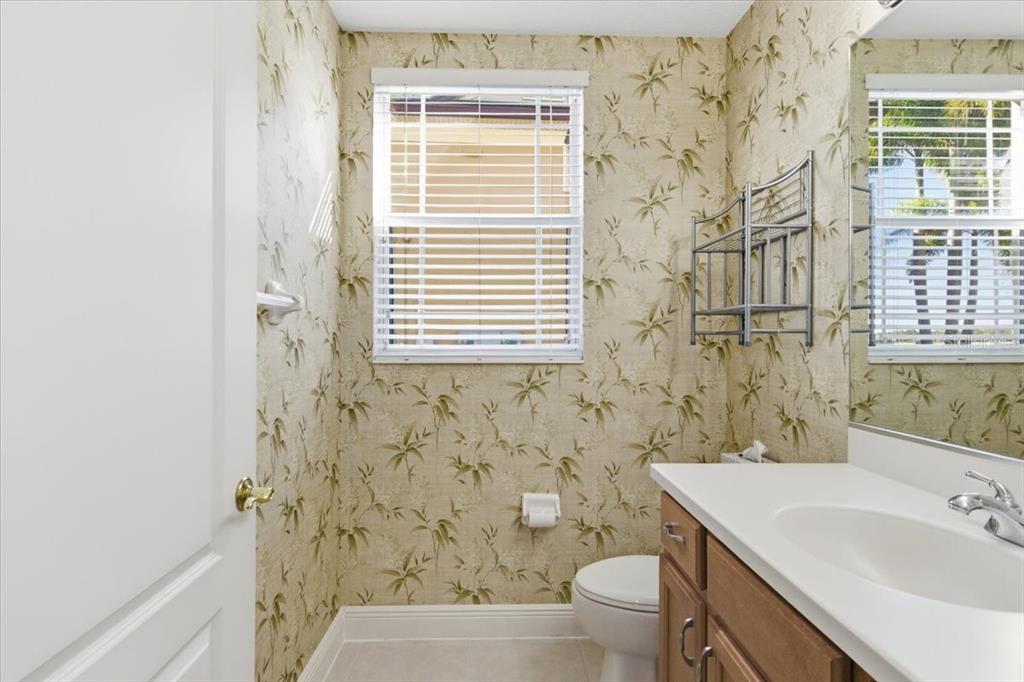 6515 Moorings Point Circle, Unit 102 Lakewood Ranch, FL 34202 - Photo 41 of 61 a bathroom with a sink a toilet and a mirror