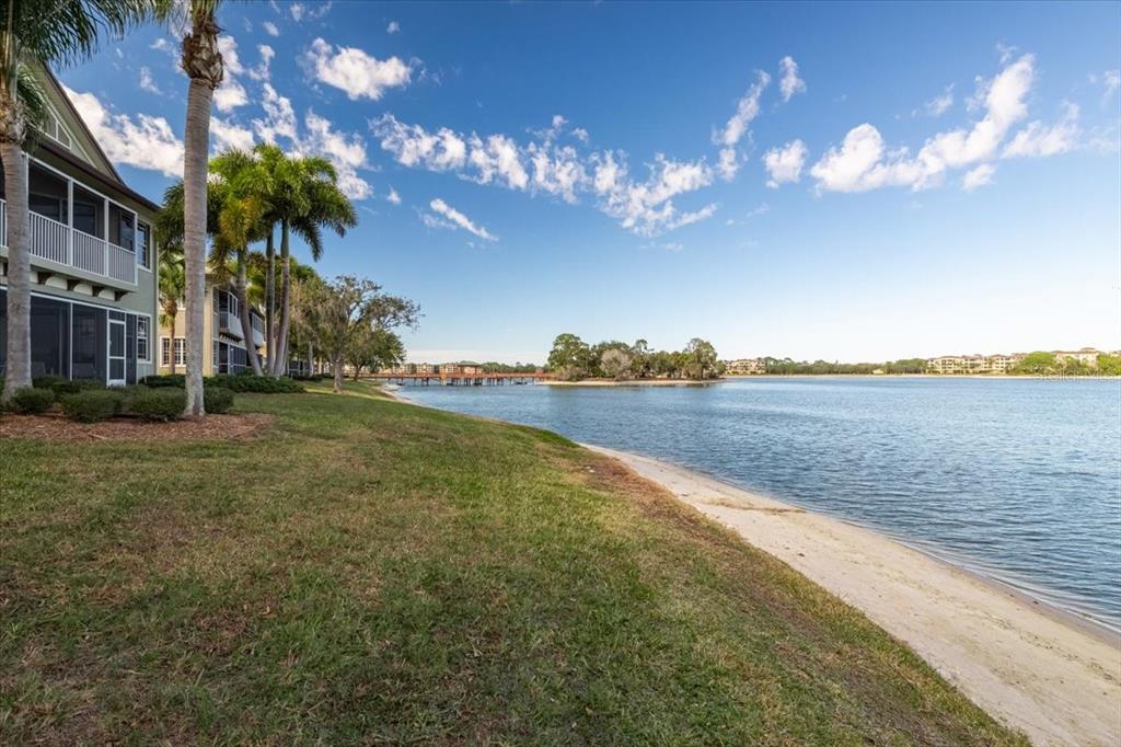 6515 Moorings Point Circle, Unit 102 Lakewood Ranch, FL 34202 - Photo 42 of 61 a view of a house with a big yard next to a large building