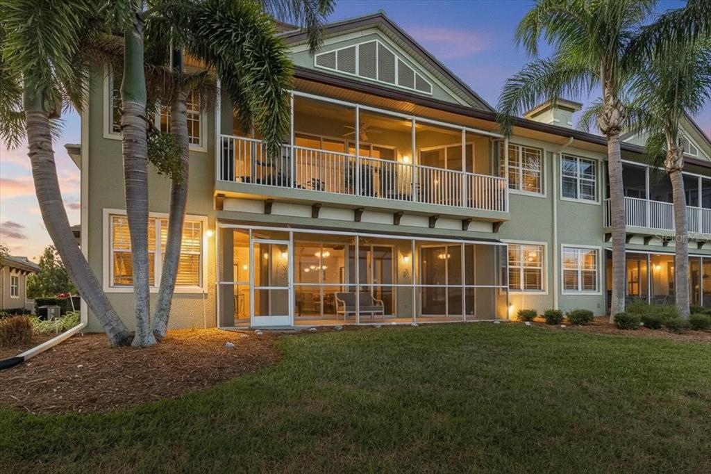 6515 Moorings Point Circle, Unit 102 Lakewood Ranch, FL 34202 - Photo 47 of 52 a front view of a house with a yard