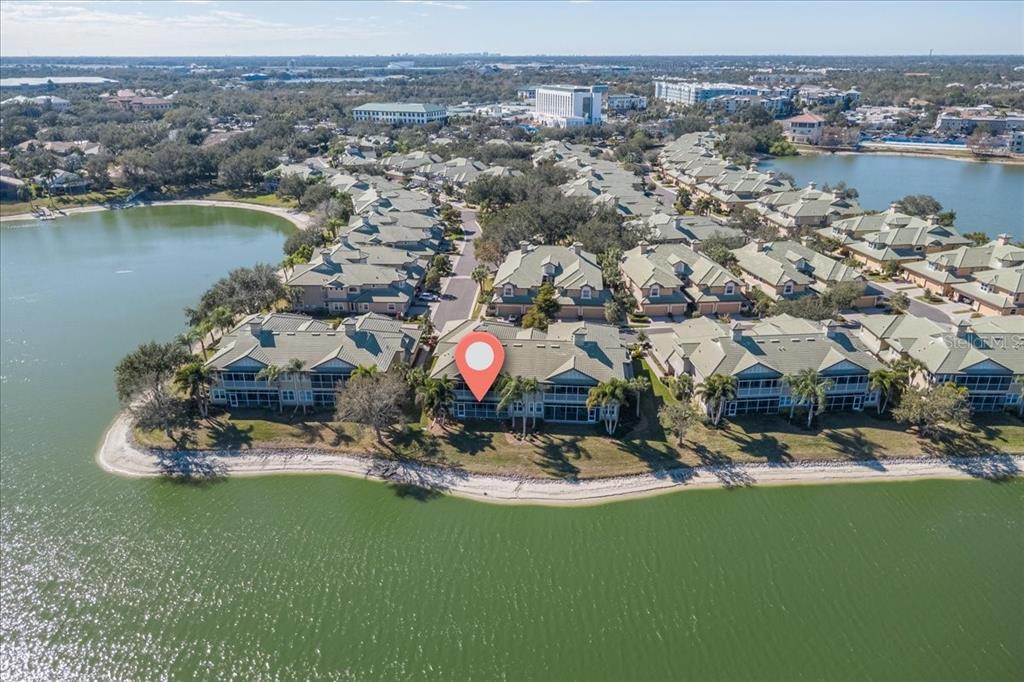6515 Moorings Point Circle, Unit 102 Lakewood Ranch, FL 34202 - Photo 50 of 52 an aerial view of a house with a swimming pool yard and lake view in back