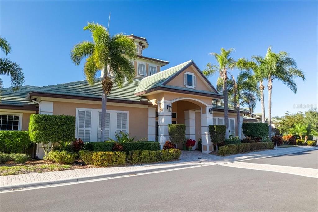 6515 Moorings Point Circle, Unit 102 Lakewood Ranch, FL 34202 - Photo 51 of 61 a front view of a house with a small garden