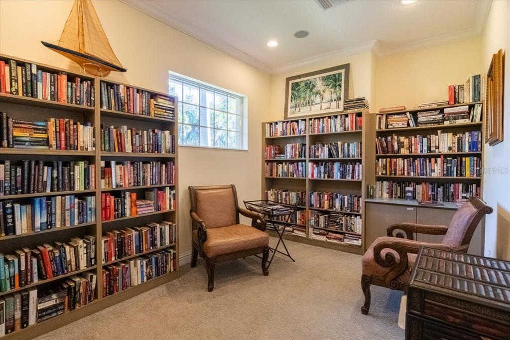 6515 Moorings Point Circle, Unit 102 Lakewood Ranch, FL 34202 - Photo 55 of 61 a view of a livingroom with workspace and a bookshelf