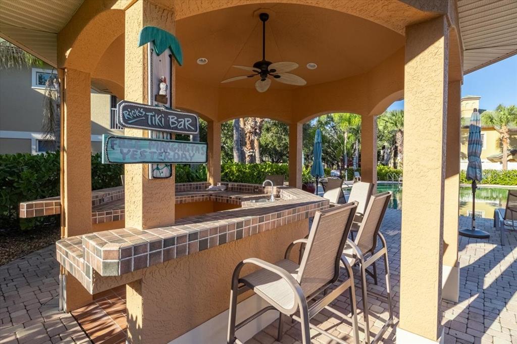6515 Moorings Point Circle, Unit 102 Lakewood Ranch, FL 34202 - Photo 59 of 61 a view of a patio with table and chairs and potted plants