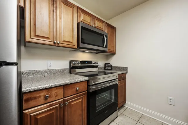 a kitchen with stainless steel appliances granite countertop a sink and cabinets