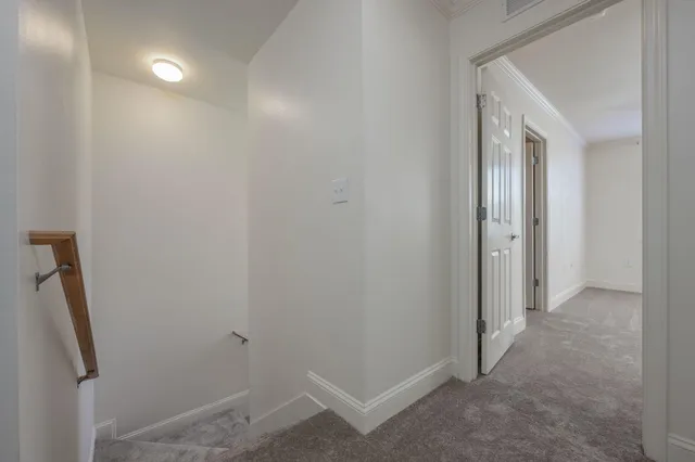 an empty room with fan and entrance