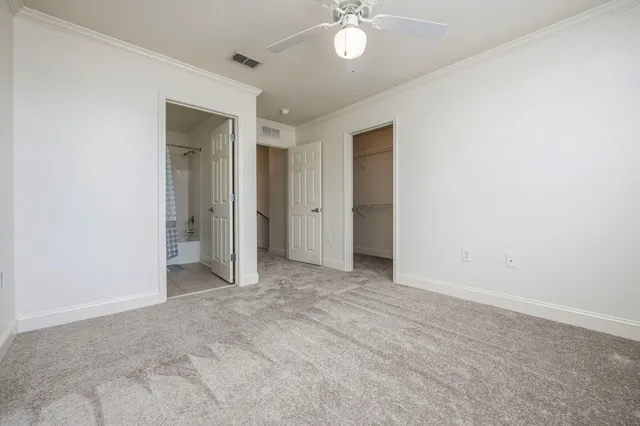 a bathroom with a granite countertop sink a toilet and shower