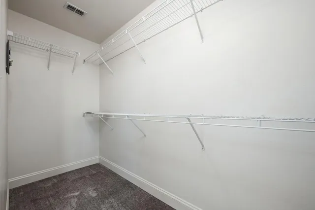 an empty room with fan and windows