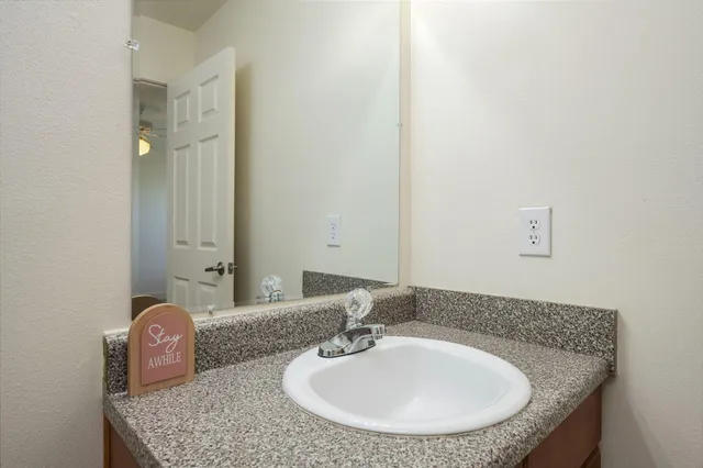 an empty room with closet and ceiling fan