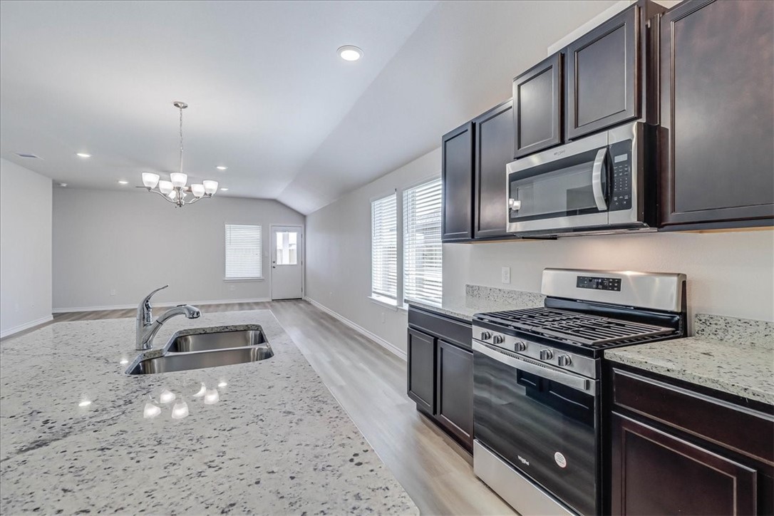 1634 Comfy Way Corpus Christi, TX 78418 - Photo 12 of 39 a kitchen with granite countertop a stove and a sink