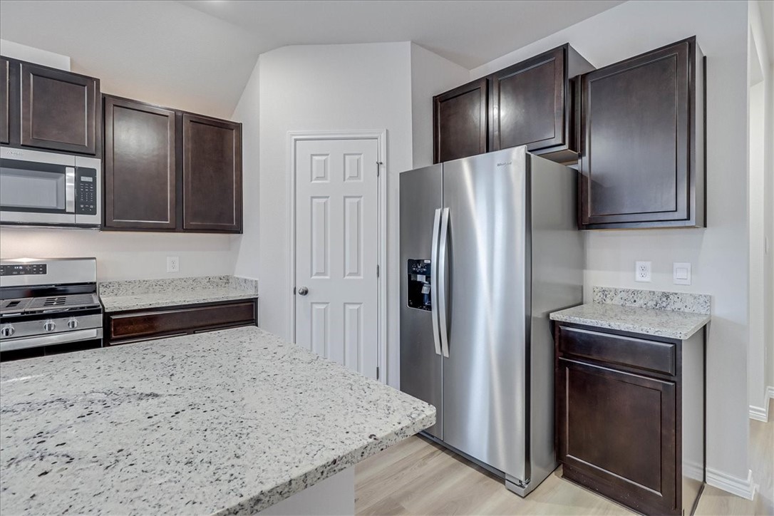 1634 Comfy Way Corpus Christi, TX 78418 - Photo 13 of 39 a kitchen with stainless steel appliances granite countertop a refrigerator and a sink